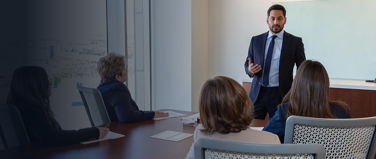 Business professional presenting to colleagues in a conference room